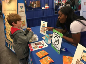 trade show staffer interacting with young guest